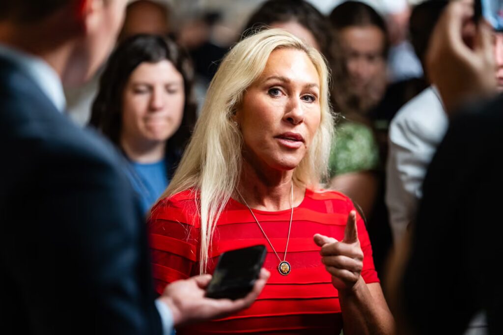 Marjorie Taylor Greene speaking at a political event as tensions rise between her and Donald Trump over the release of the Epstein files.