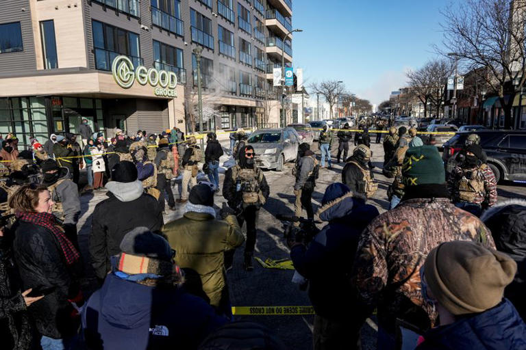 Federal agents at the scene of a Minneapolis immigration enforcement operation following a fatal shooting during an intensified immigration crackdown