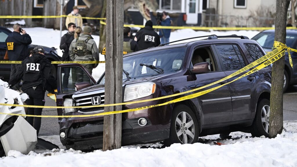 Federal ICE agents surrounding a vehicle in Minneapolis following the fatal shooting of Renee Good