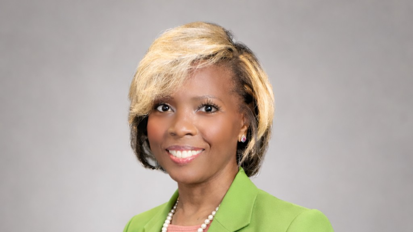 Dr. Teresa A. Smith (Dr. TAS) speaking on leadership and personal transformation, smiling with confident posture, professional background, and engaging audience presence.