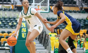 Da’Brya Clark celebrates during a women’s college basketball game after transferring from Norfolk State to Charlotte to play for coach Tomekia Reed.