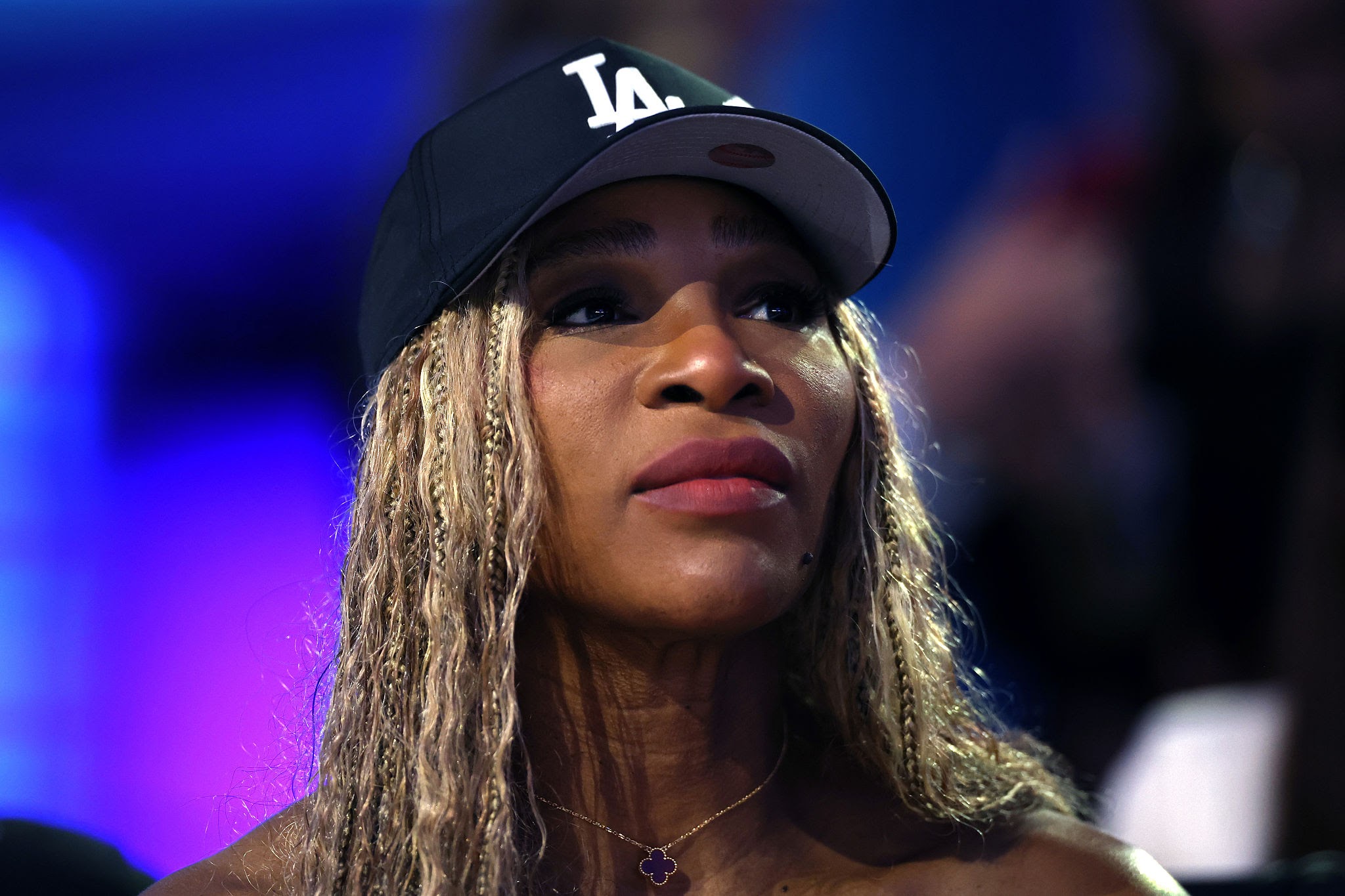 Serena Williams smiles while standing on a tennis court ahead of her professional return at Queen's Club in London after a four-year hiatus from competition.