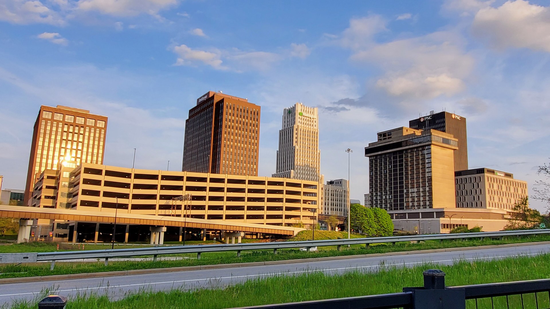 Downtown Akron Ohio skyline at sunset with office towers and a parking deck
