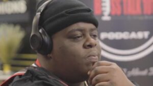BigXthaPlug in a black beanie wearing headphones during a podcast interview