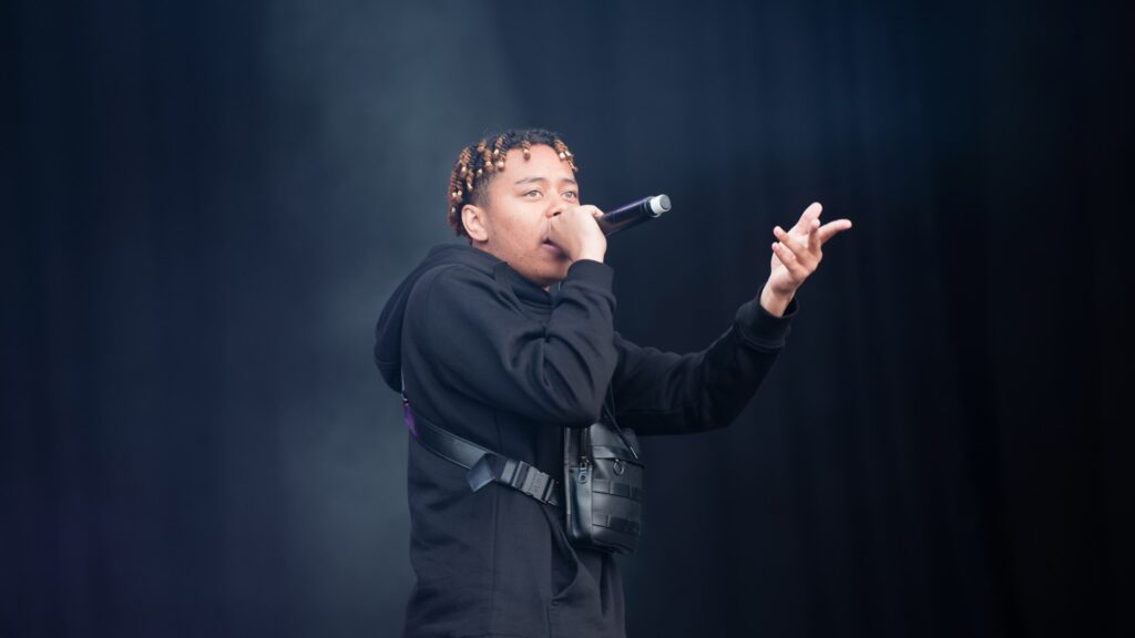 Cordae performing live on stage in 2019