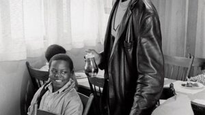 Black Panther Party member serves free breakfast to children in a community kitchen
