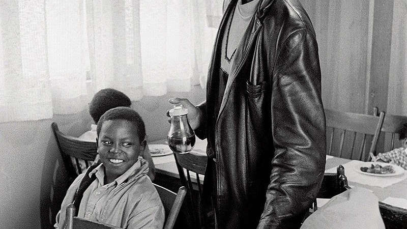 Black Panther Party member serves free breakfast to children in a community kitchen