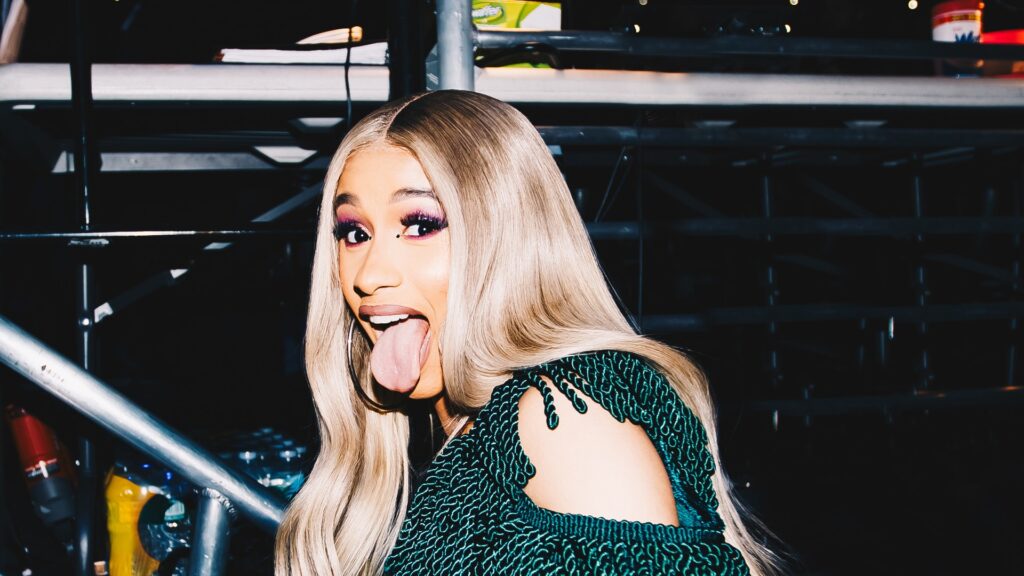 Cardi B backstage in a green fringe outfit