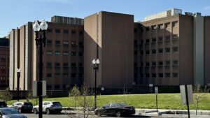 The Central Detention Facility in Washington DC behind a fence and trees
