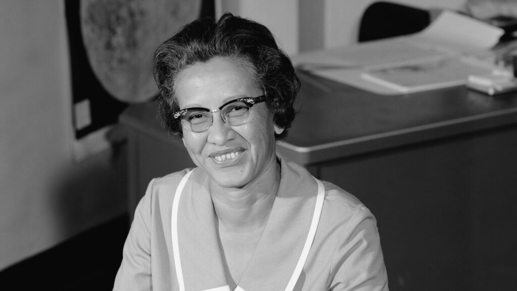 Katherine Johnson smiling at her desk at Langley Research Center in 1966
