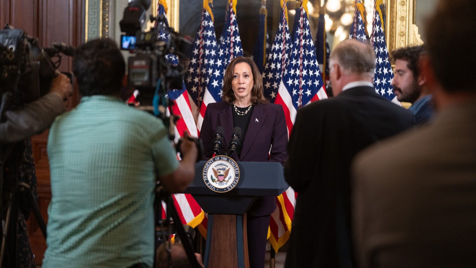 Kamala Harris speaking at a podium during an appearance