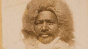 Portrait of Matthew Henson wearing a fur parka in the Arctic