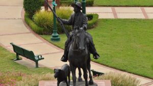 Bronze statue of Bass Reeves on horseback holding a rifle in Fort Smith Arkansas