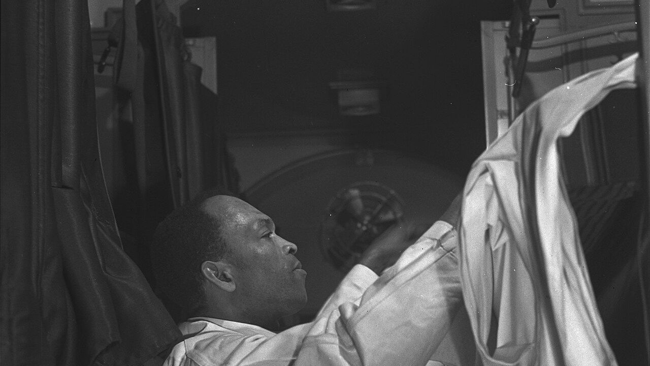 Pullman porter making up an upper berth on a train bound for Chicago