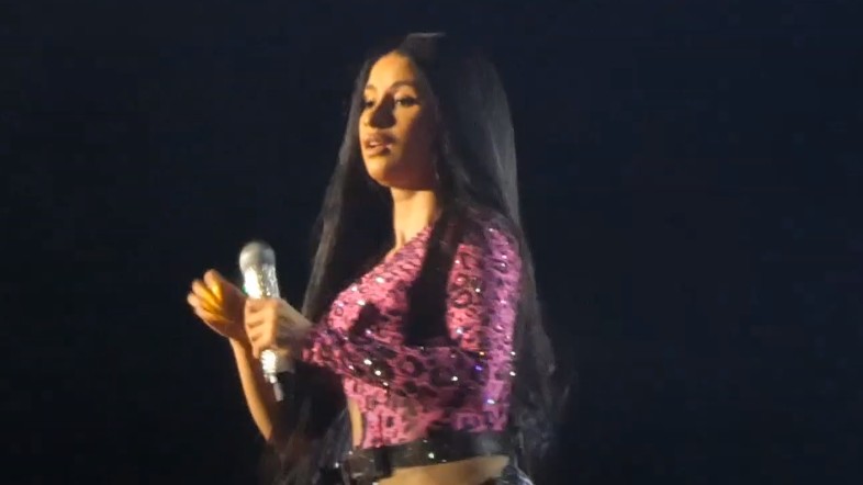 Cardi B performing live on stage with a microphone