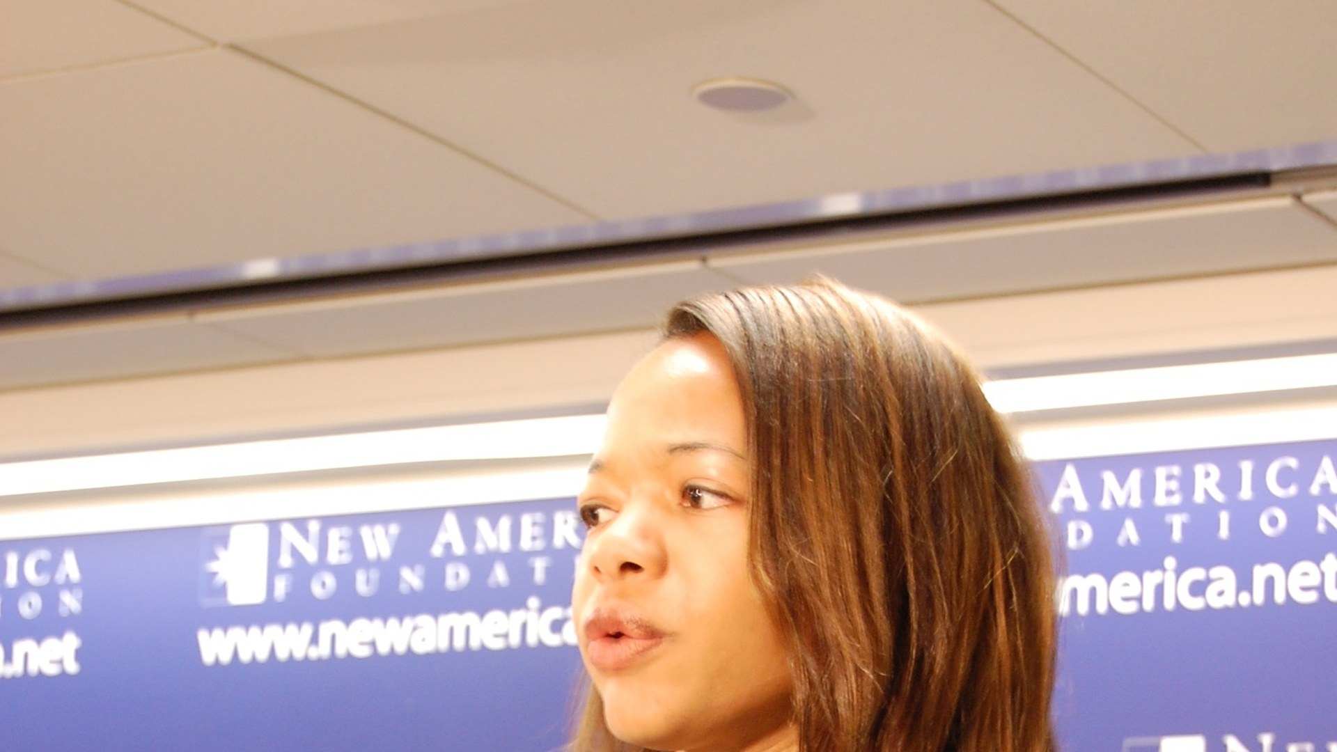 Kristen Clarke speaking at a public panel discussion