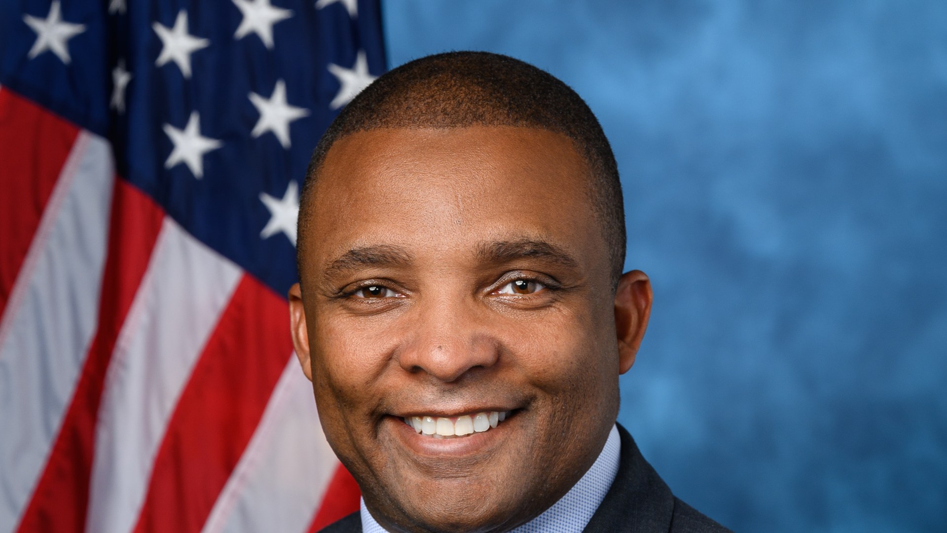 Representative Don Davis official portrait in front of an American flag