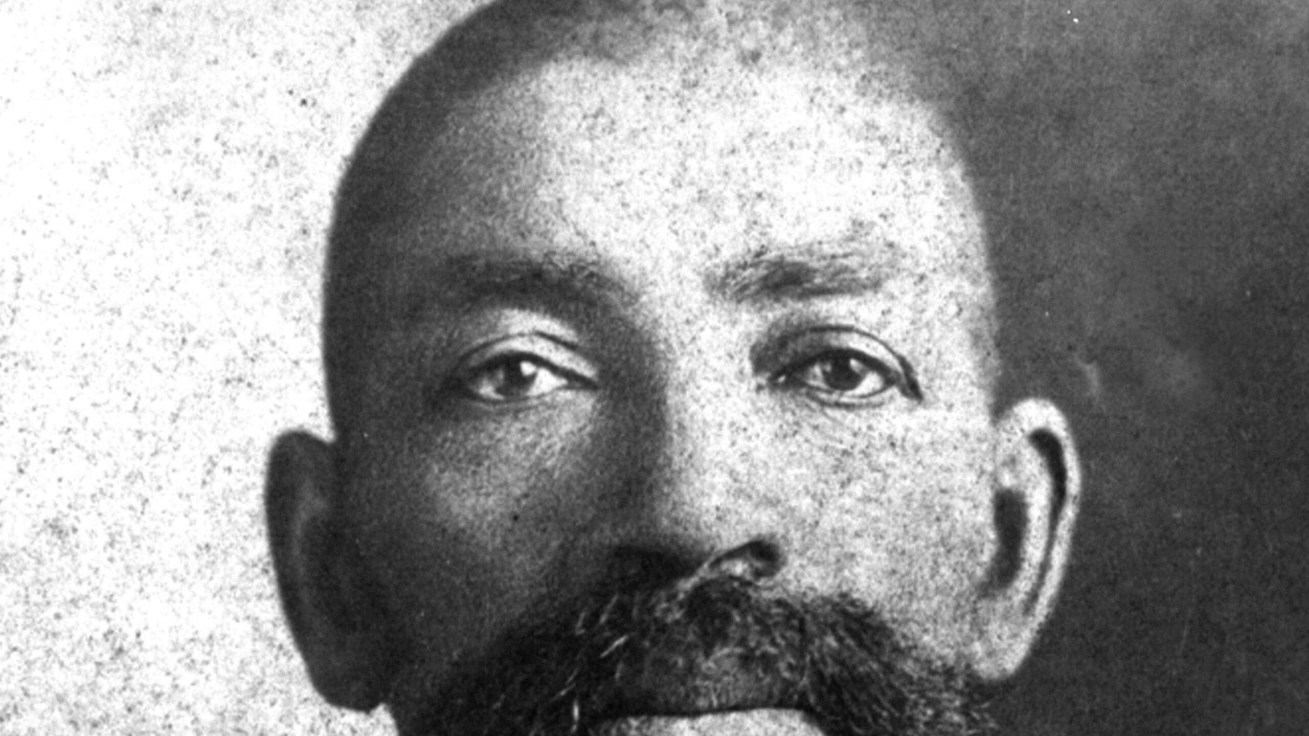 Portrait of Bass Reeves with a large mustache wearing a suit and bow tie