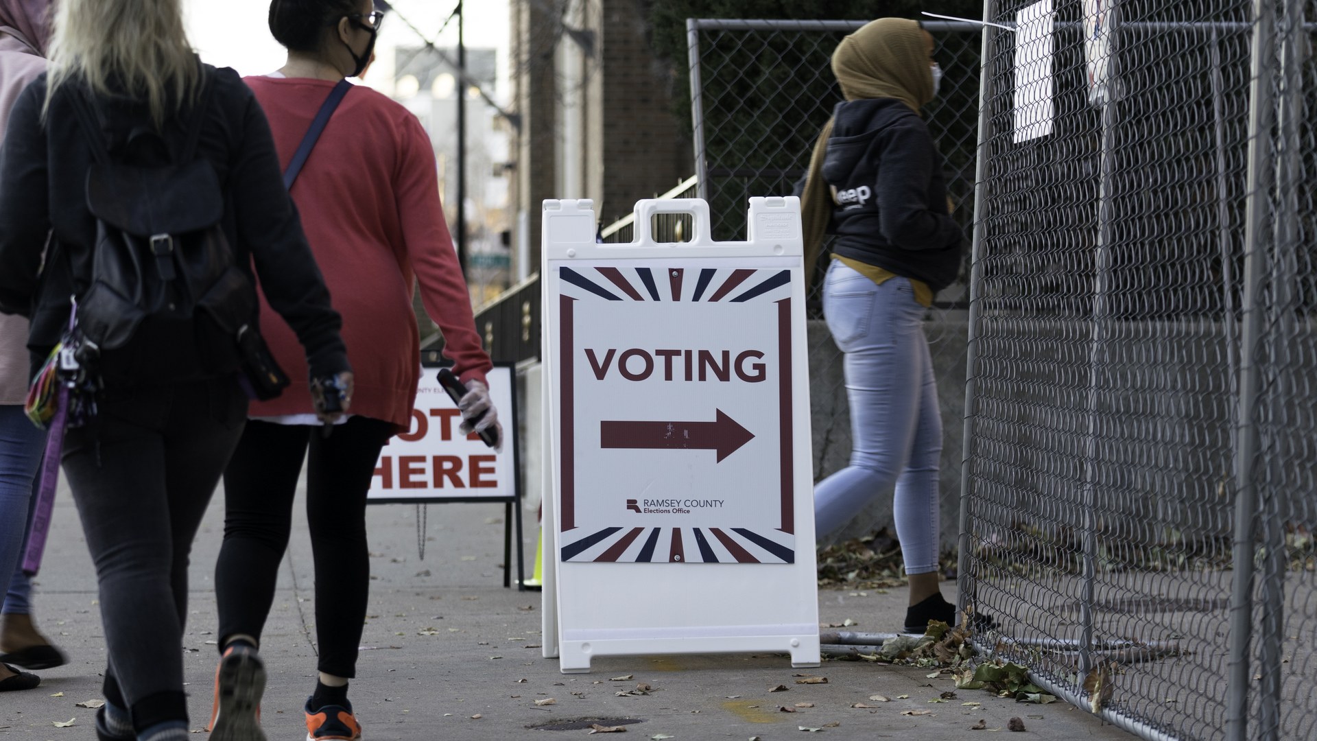 Voters walk past a voting sign outside a polling place in St Paul Minnesota