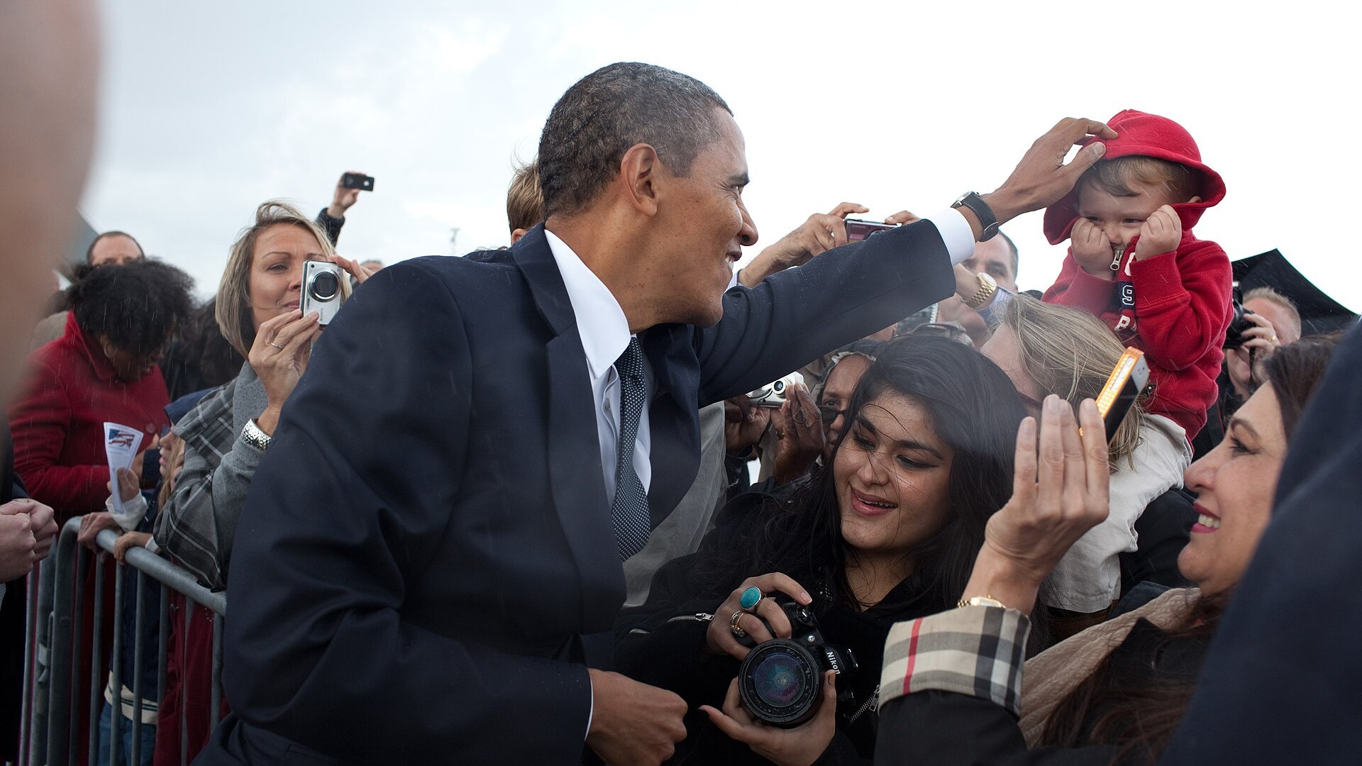 Barack Obama greets people after arriving in Detroit Michigan