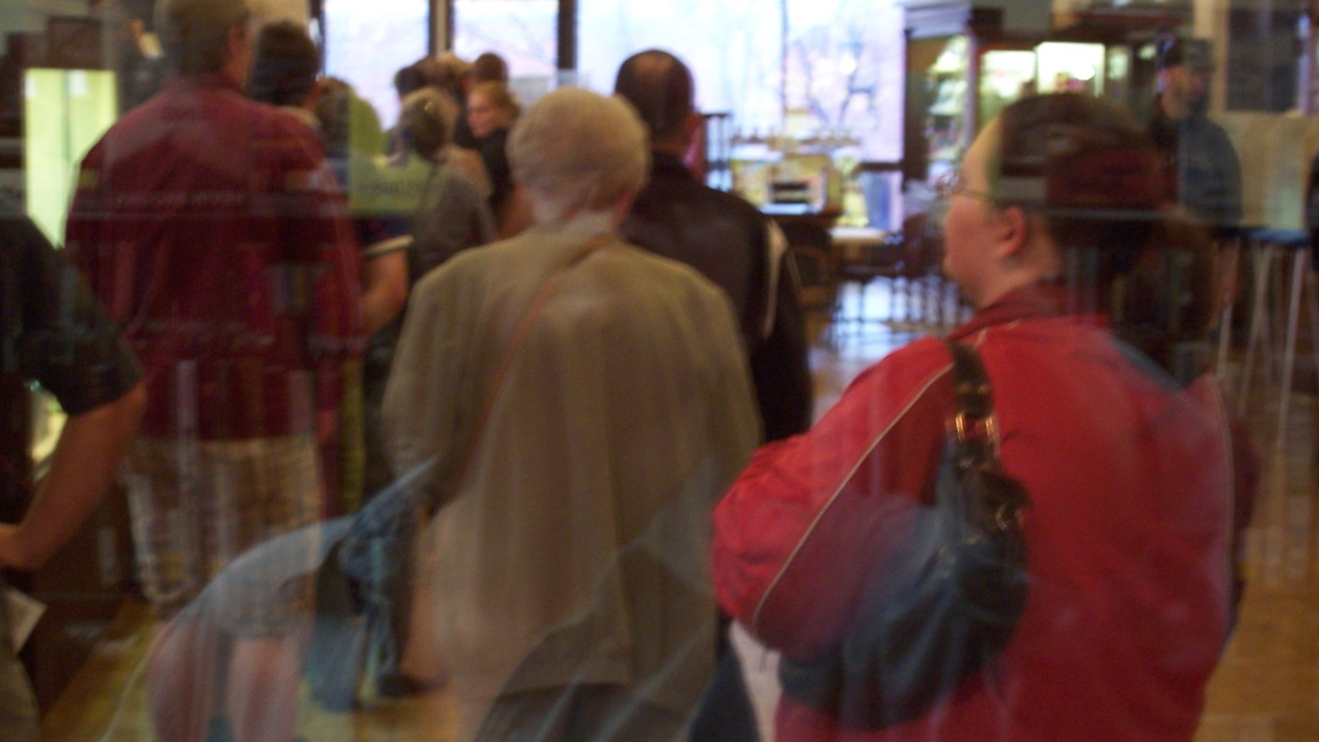 Voters wait in line at a polling place to cast their ballots