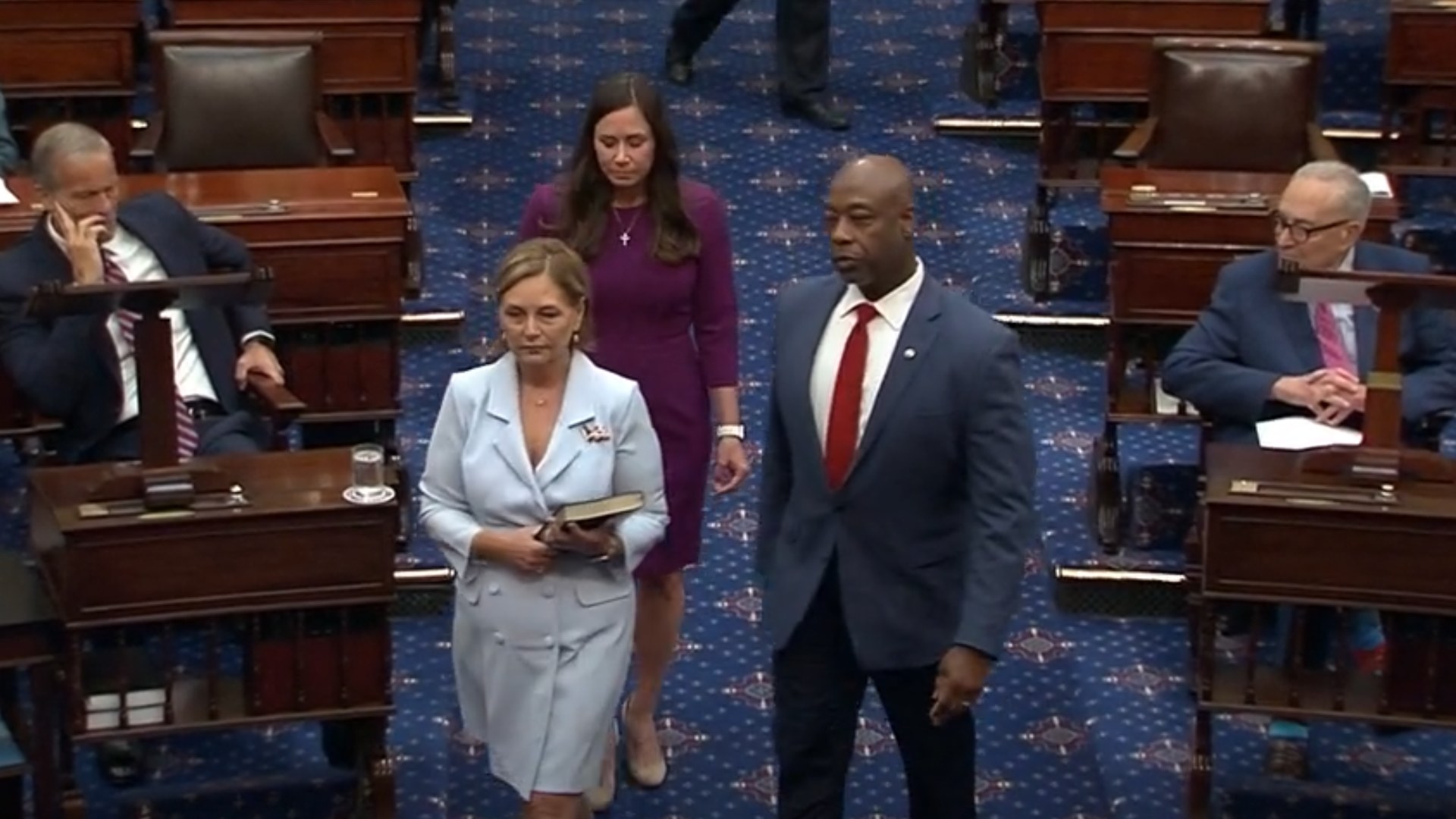 Darline Graham walks onto the Senate floor beside Tim Scott at her swearing in