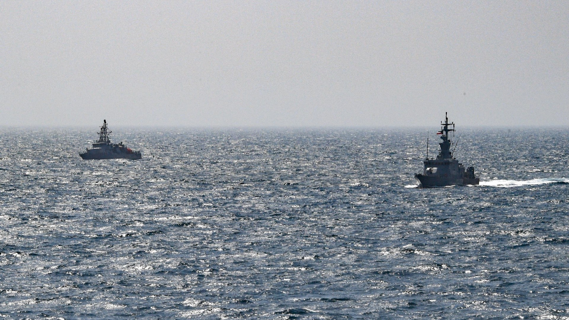United States and Kuwaiti patrol ships sailing in formation on the waters of the Gulf