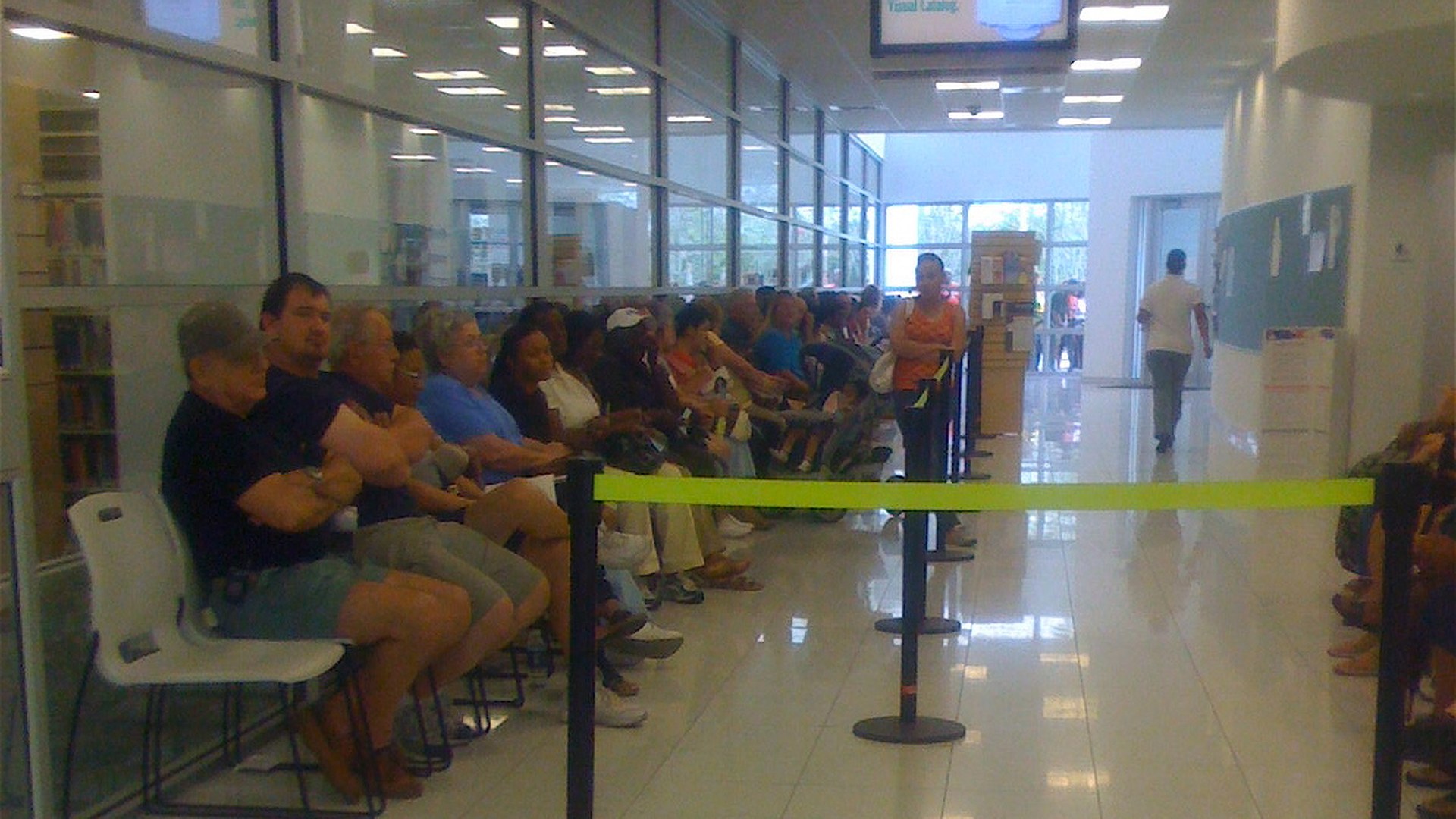 Early voters seated in a long line inside a polling place