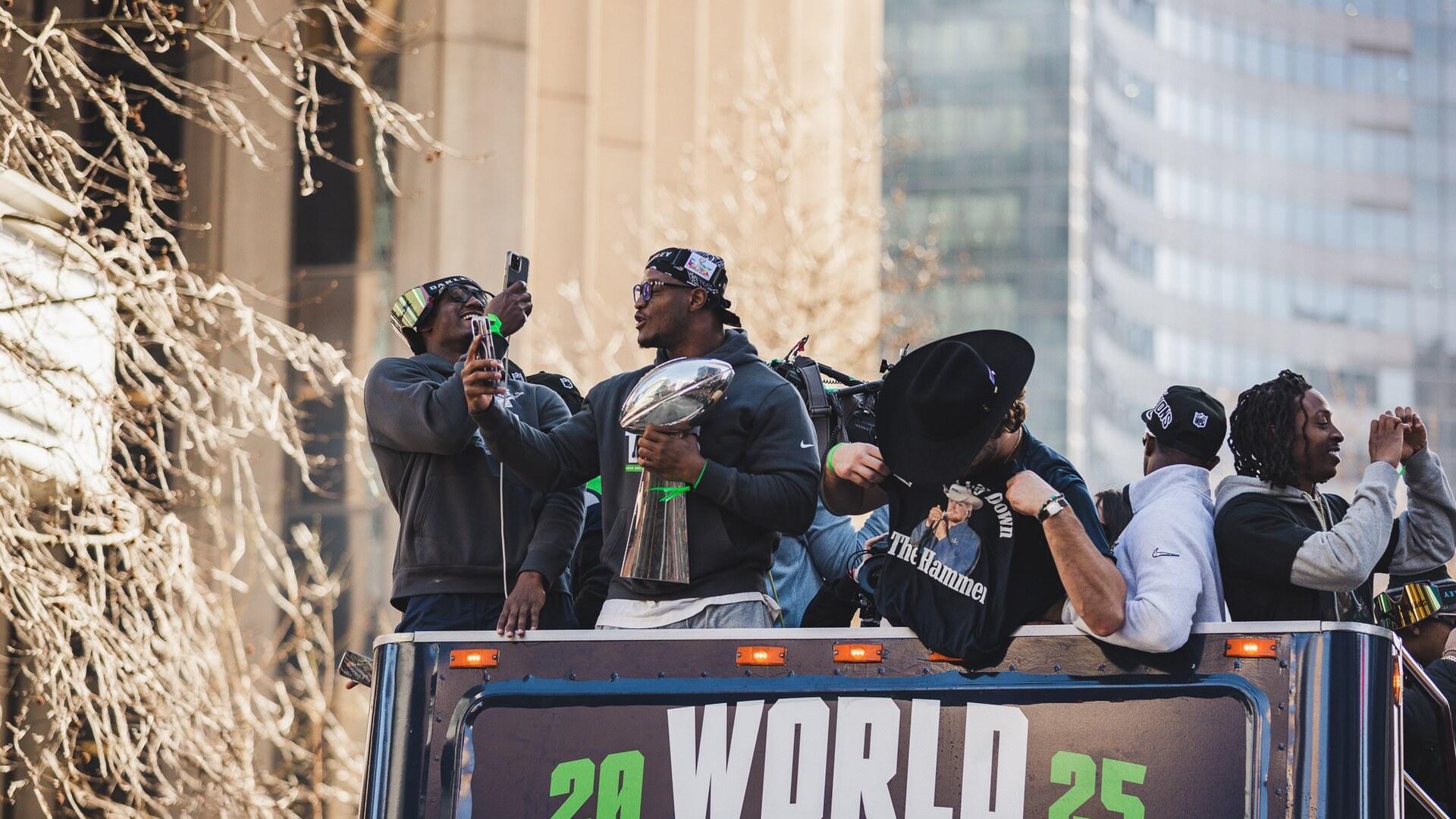 Kenneth Walker III holds the Lombardi Trophy at the Super Bowl LX victory parade
