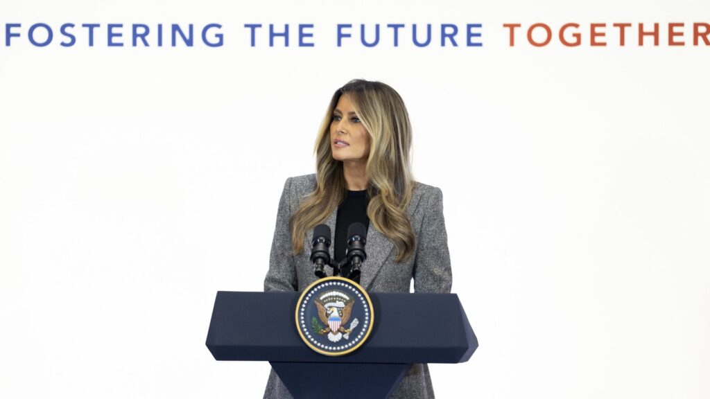 First Lady Melania Trump speaking at a podium during the Fostering the Future Together summit