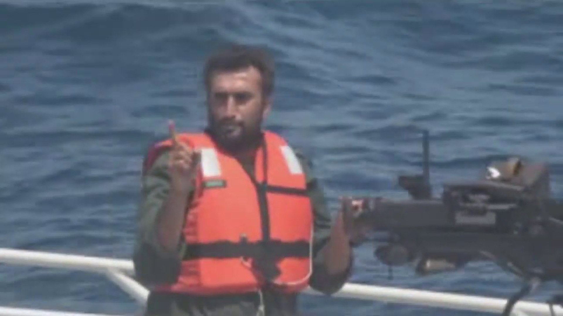 Iranian Revolutionary Guard Corps Navy gunner warning a US Navy warship