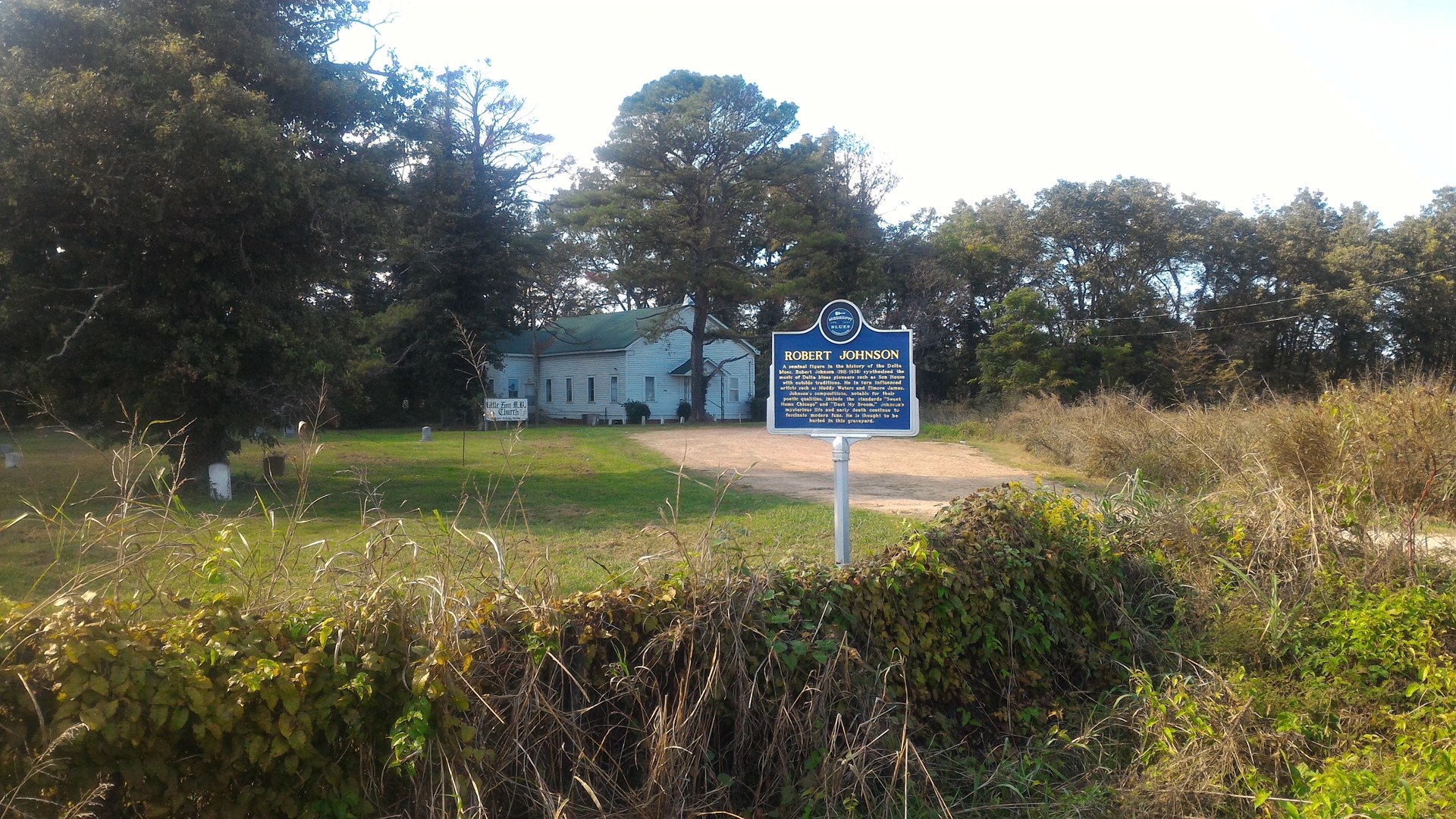 Robert Johnson Mississippi Blues Trail marker at sunset