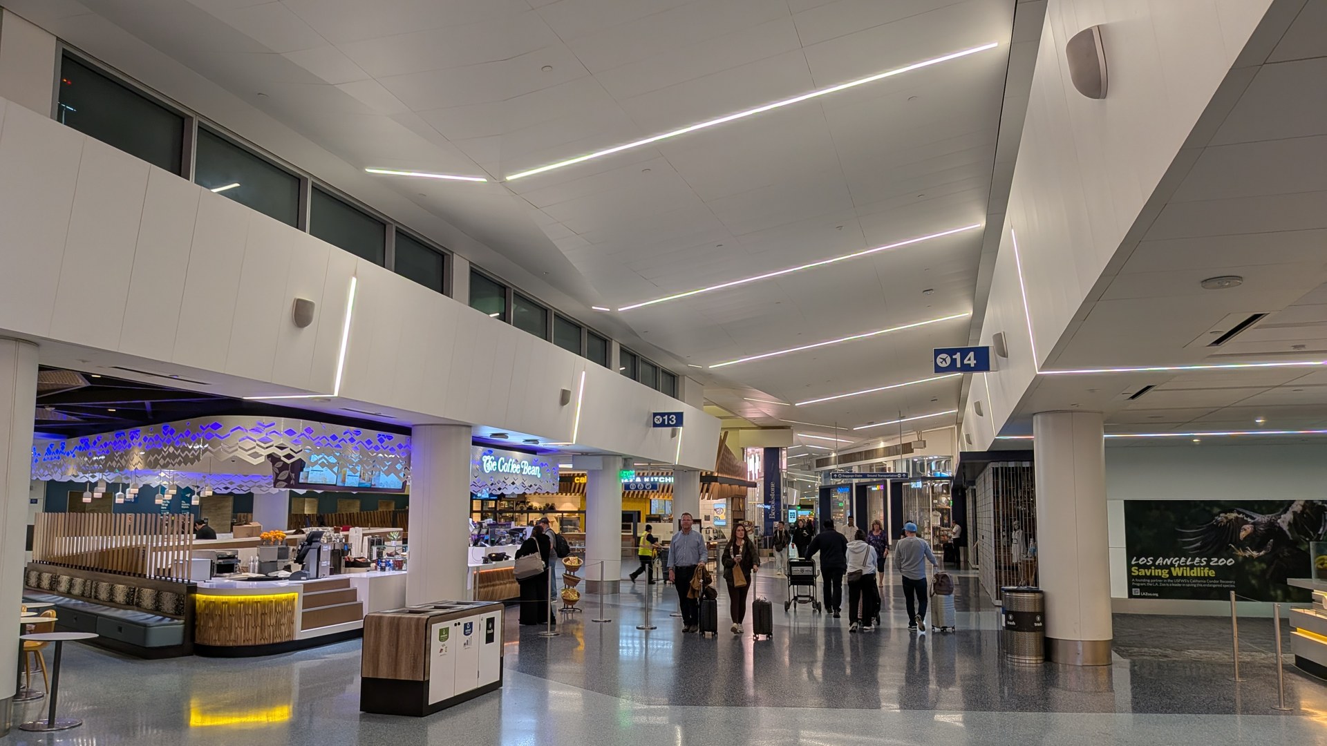 Travelers walking through Terminal 1 at Los Angeles International Airport near food counters