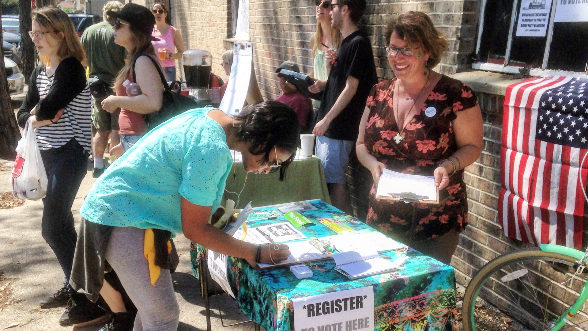 Residents signing up at a voter registration table in New Orleans