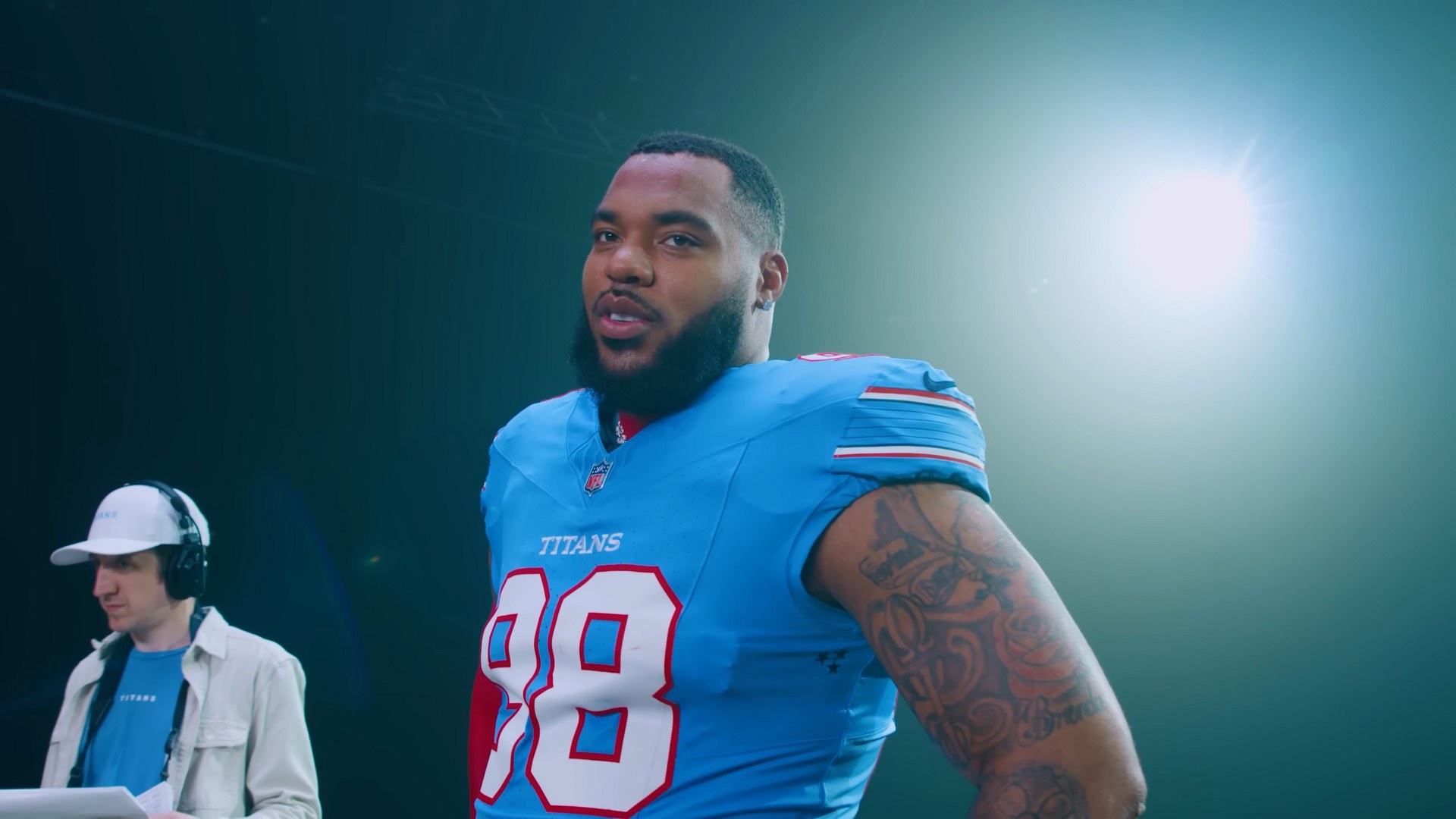 Jeffery Simmons posing in a Tennessee Titans jersey during a team photo shoot