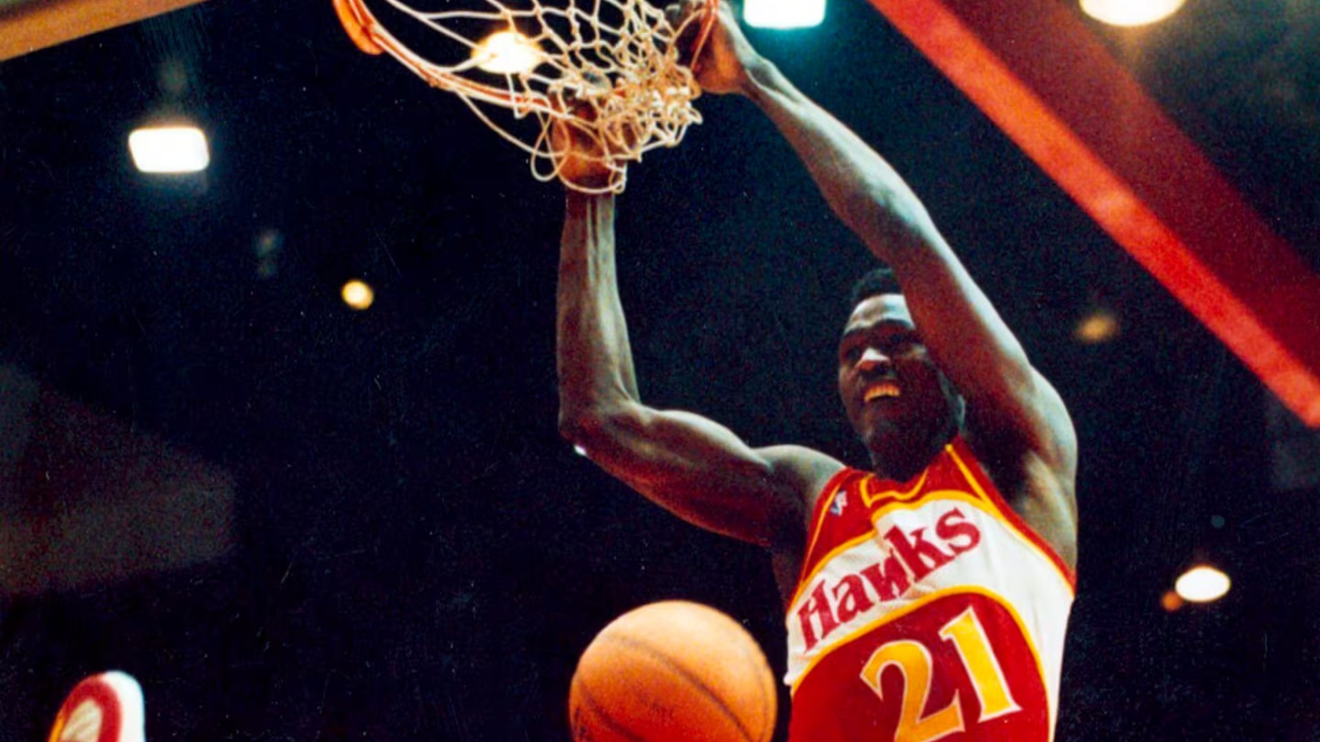 Dominique Wilkins dunking in his Atlanta Hawks number 21 jersey during the 1988 dunk contest