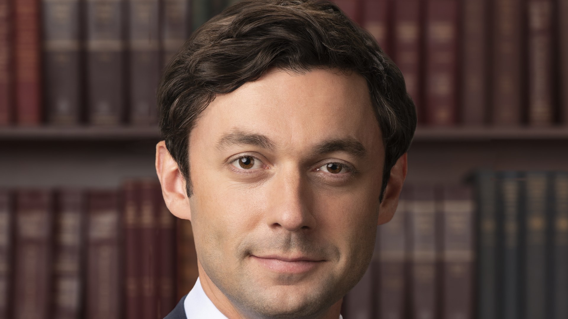 Jon Ossoff official portrait in front of a bookshelf